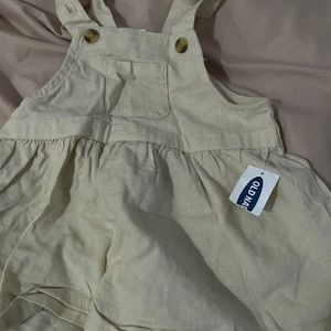 The brand of the dress is from old navy.The color is cream it’s never worn .